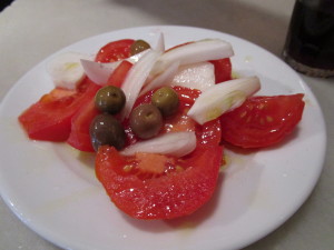 Tomatoes, onions and olives in olive oil